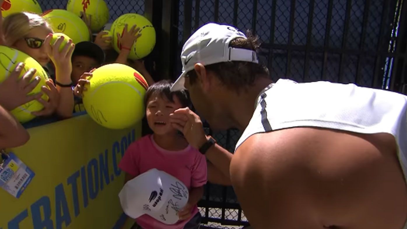 Rafael Nadal comforts a young fan