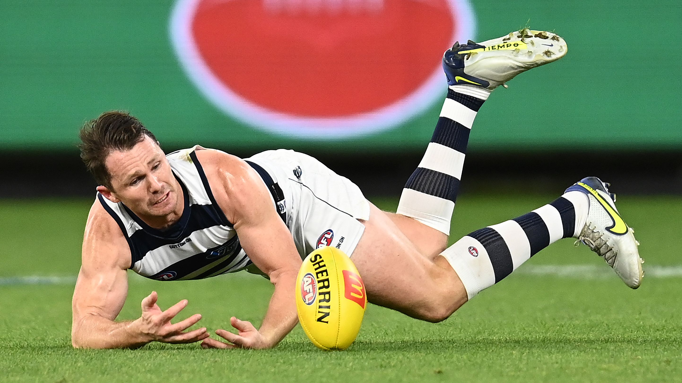 Patrick Dangerfield of the Cats dives for a mark.