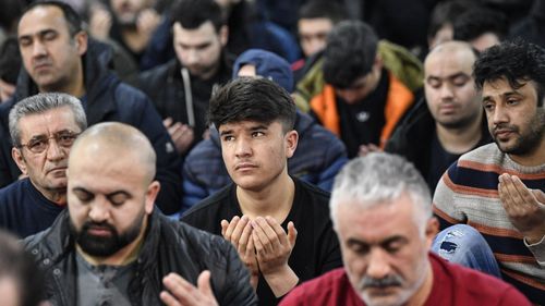 Muslim believers pray in a mosque for the victims of the shooting in Hanau, Germany, Friday, Feb. 21, 2020.