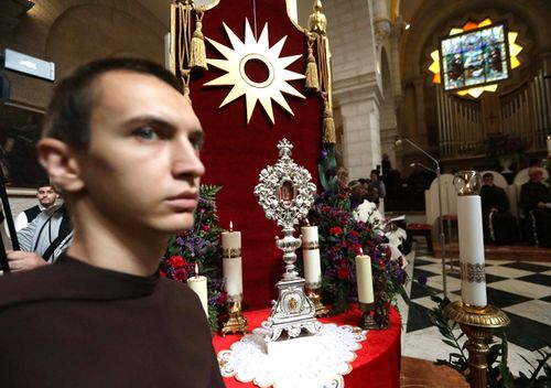 Franciscan friars of the Custody of the Holy Land take part in a procession with a small piece of the Relic of the Holy Crib of the Child Jesus, a gift from Pope Francis to the Custody of the Holy Land, to the church of St Saviour, in the West Bank city of Bethlehem.