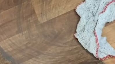 Woman cleans her floor on TikTok