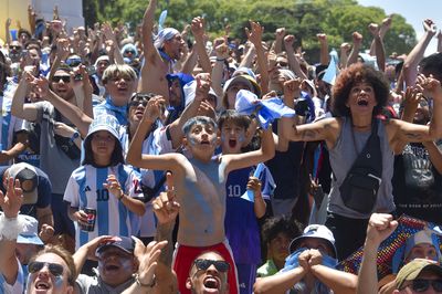 Argentina's soccer fans react as they watch on big screens the World Cup final soccer match between Argentina and France in Buenos Aires.