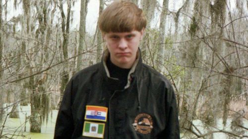 A Facebook photo of Dylann Roof, showing him wearing patches of the apartheid-era South African flag and the flag of white-ruled Rhodesia.