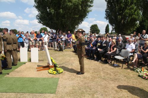 Major General Matthew Hall salutes the headstone of an unknown Australian WW1 soldier at Tyne Cot Cemetery in Zonnebeke, Belgium.  