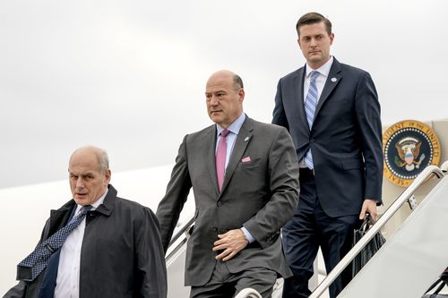 Rob Porter (right) disembarks a plane with fellow White House staff. (AAP)