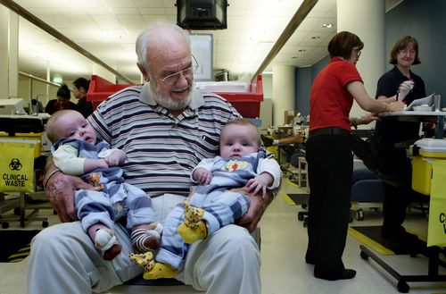 Portrait of James Harrison 72 (2nd from left) with twin boys Seth Murray O+ (left) and Ethan Murray  O-(3rd from left) in the Apheresis department at the Australian Red Cross Blood Service. Hundreds of thousands of babies owe their health and in some cases their life to James Harrison as his blood has been used in every dose of anti-D serum since 1967, which is given when the blood types of mothers and babies are incompatible. Red Cross, Sydney, NSW. Today 20th of May, 2009. Photo by KATE GERAGH