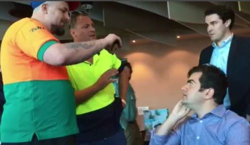 Erikson is seen wearing a Toll uniform as he films Senator Sam Dastyari at a Melbourne pub last year. 