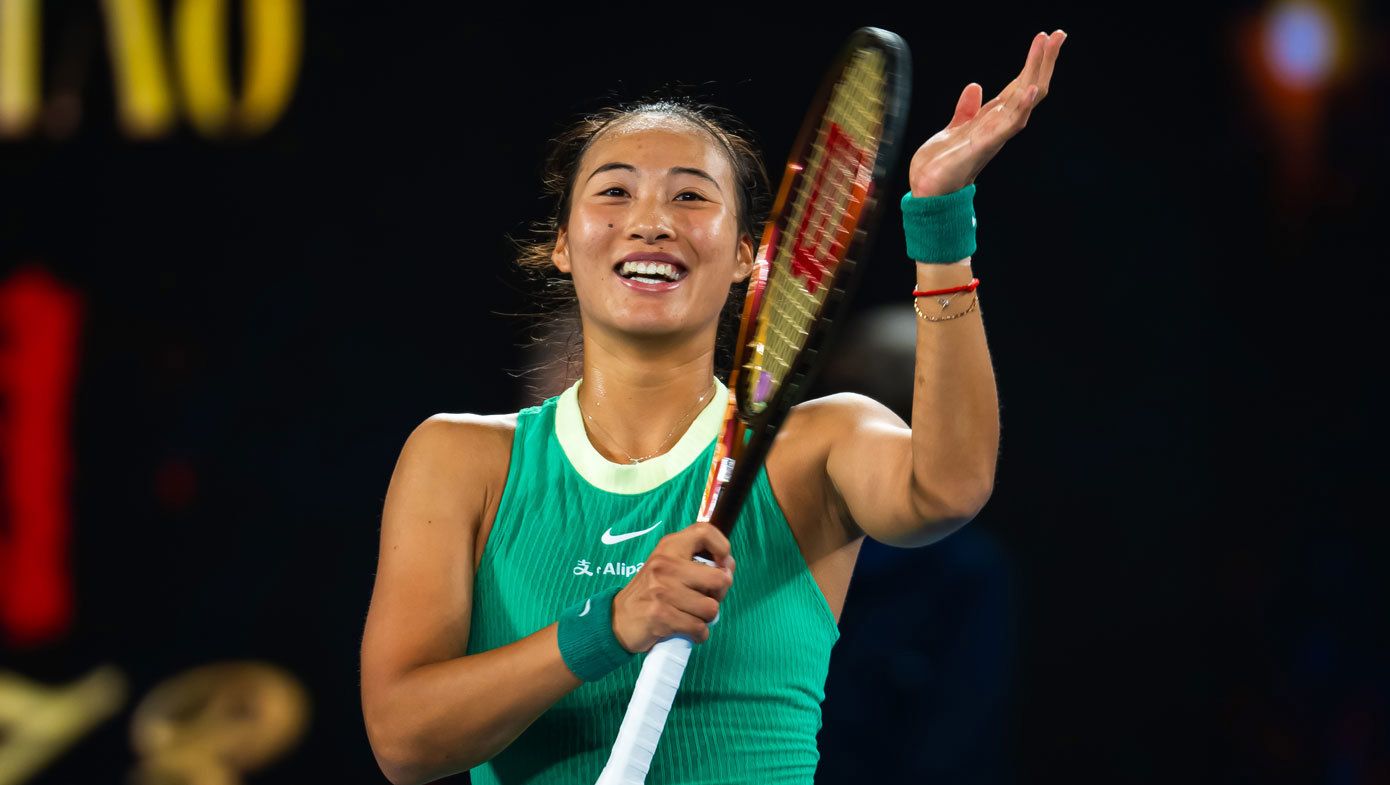 Qinwen Zheng applauds with her racquet after winning her Australian Open semi-final in 2024.