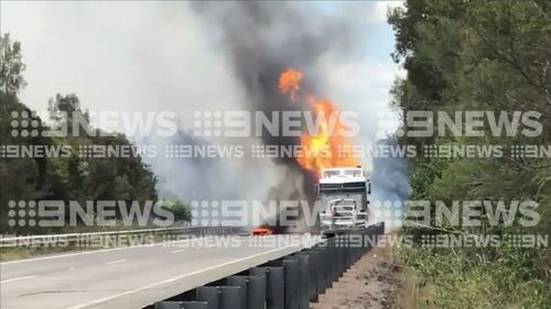 A bushfire was sparked after two trucks crashed on the motorway. (9NEWS)
