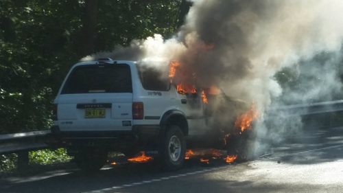 Driver walks free after car bursts into flames on NSW Central Coast