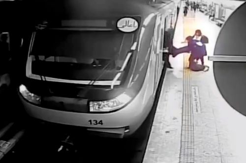 Women pull Armita Geravand from a train car on the Tehran Metro in Tehran