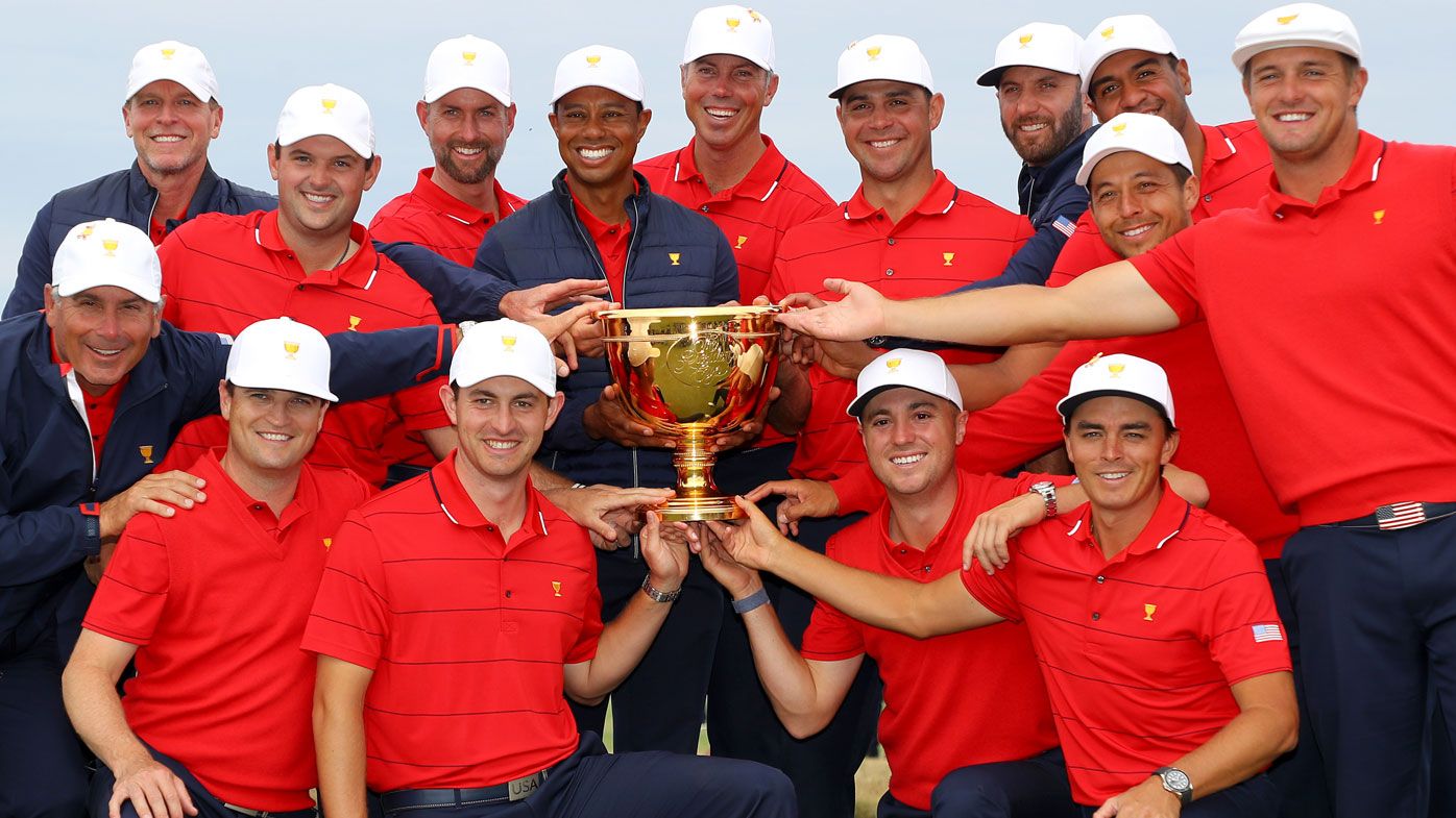 Assistant Captain Steve Stricker, Patrick Reed, Webb Simpson, Playing Captain Tiger Woods, Matt Kuchar, Gary Woodland, Dustin Johnson, Tony Finau, Xander Schauffele, Bryson DeChambeau, (front L-R) Assistant Captain Fred Couples, Assistant Captain Zach Johnson, Patrick Cantlay, Justin Thomas and Rickie Fowler of the United States team celebrate with the cup 