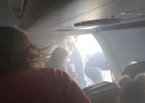 Passengers prepare to leave the plane at Valencia Airport using an emergency slide. Image courtesy Lucy Brown, Twitter.