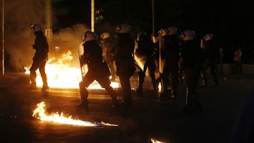 Petrol bombs have been thrown at police outside the Greek parliament. (AAP)