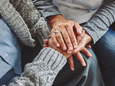 Woman holding man's hand