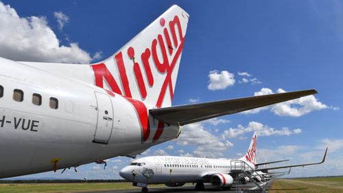 Grounded Virgin Australia aircraft are seen parked at Brisbane Airport in Brisbane