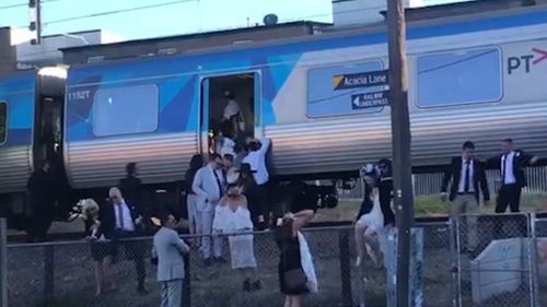 The hot, crowded trains left some racegoers with no choice but to push open the train doors. (Sean Davidson)