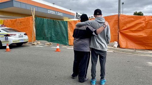 Two boys whose friend was killed when the three of them were sleeping rough in a skip bin embrace in Port Lincoln, South Australia.