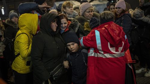 Displaced Ukrainians queue to board a bus to Poland outside Lviv train station in western Ukraine on Saturday, March 5, 2022. Russian troops took control of the southern port city of Kherson this week. Although they have encircled Kharkiv, Mykolaiv, Chernihiv and Sumy, Ukrainian forces have managed to keep control of key cities in central and southeastern Ukraine, Ukrainian President Volodymyr Zelenskyy said Saturday. (AP Photo/Bernat Armangue)