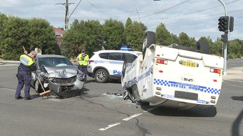 The safety of police caged trucks is in question after one crashed while heading to a job in Sydney's East.Two luxury cars were damaged in the collision but the officers escaped serious injury.