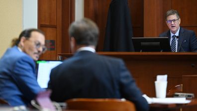 Douglas Bania (R), licensing and damages expert, testifies in the courtroom at the Fairfax County Circuit Court in Fairfax, Virginia, on May 24, 2022.
