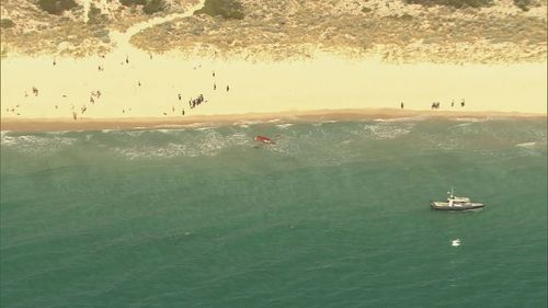 A light aircraft ditched into the ocean off Perth's City Beach with a pilot and passenger on board escaping