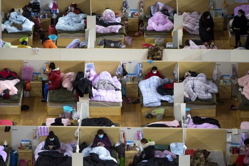 Patients infected with the coronavirus take rest at a temporary hospital converted from Wuhan Sports Center in Wuhan in central China's Hubei Province.