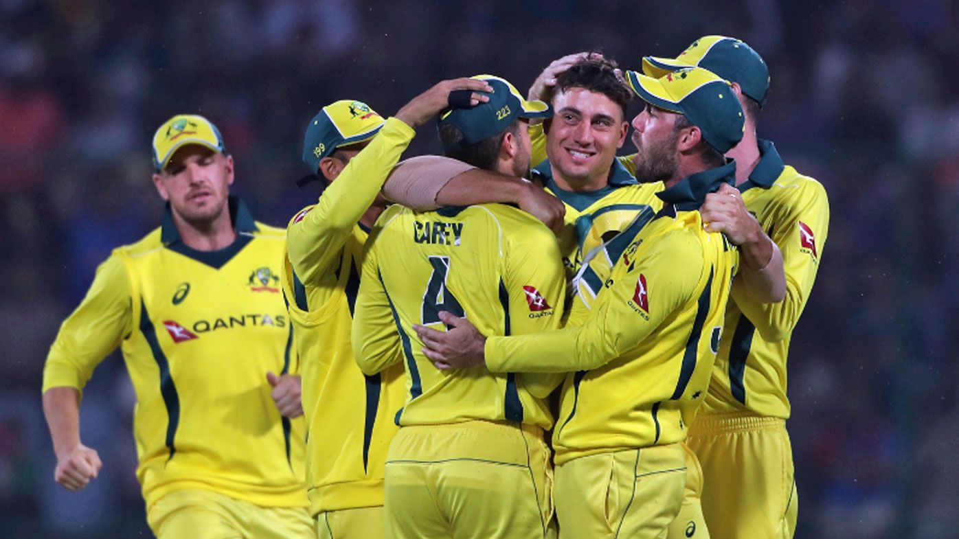 Australia's players celebrate the dismissal of India's captain Virat Kohli.