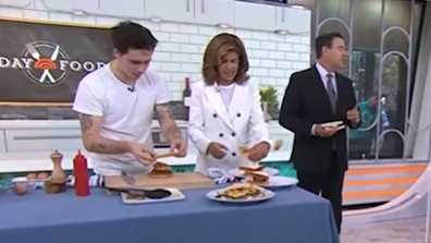 Brooklyn Beckham makes a bacon, sausage and egg sandwich during a cooking segment on the US Today Show