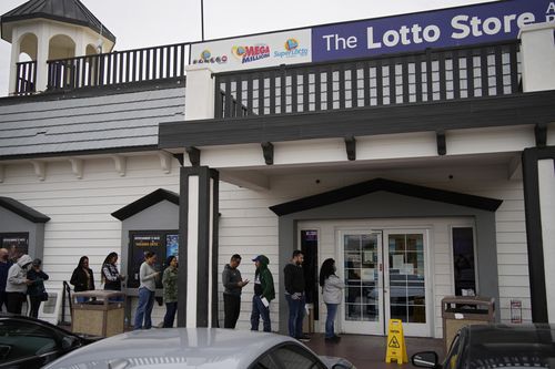 People wait in line at the Lotto Store at Primm just inside the California border, Friday, Jan. 13, 2023, near Primm, Nev. Mega Millions players will have another chance Friday night to end months of losing and finally win a jackpot that has grown to $1.35 billion