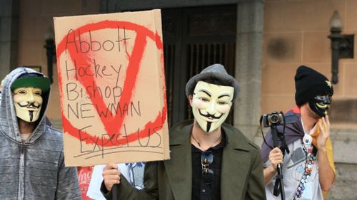 Anonymous members march in Brisbane. (AAP)