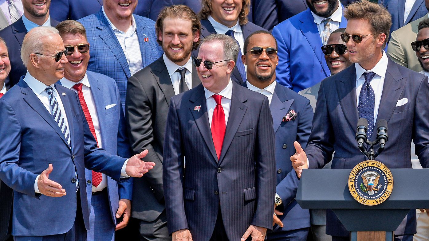 U.S. President Joe Biden laughs as quarterback Tom Brady jokes while speaking as the 2021 NFL Super Bowl champion Tampa Bay Buccaneers are welcomed to the South Lawn of the White House