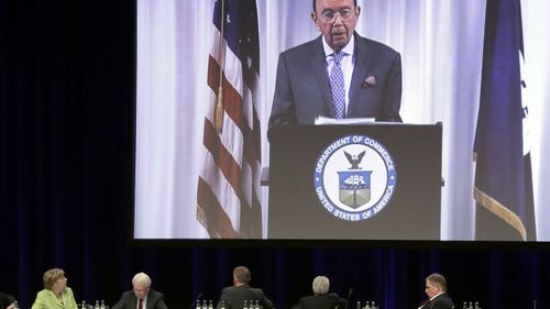 Angela Merkel listens to an overtime Wilbur Ross. (AAP)