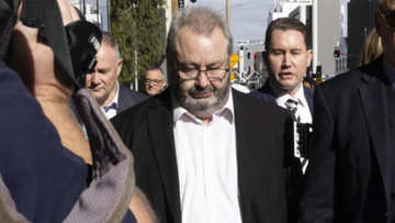 Brett Button leaves Newcastle Court flanked by family and his legal team on April 3, 2024