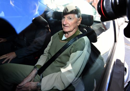 Vincent O'Dempsey sits in the back of a police car. Queensland Police said Mr O'Dempsey was 'surprised' when they turned up for him today.