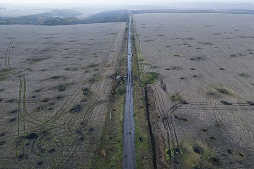 Artillery craters are seen in the field from an aerial view in the recently liberated area of Kharkiv region, Ukraine, Friday, September 30, 2022 