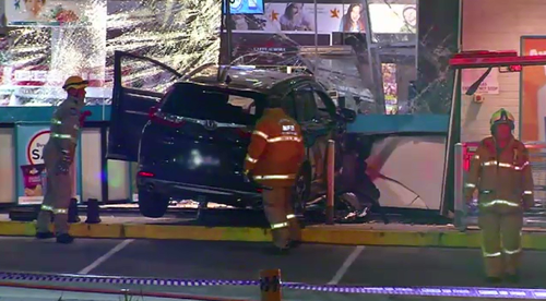 A service attendant at the Mount Waverley business was also injured when the car rammed through the glass entrance. 