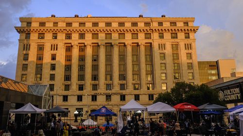 Media vehicles outside the Fulton County Courthouse, Monday, in Atlanta. 