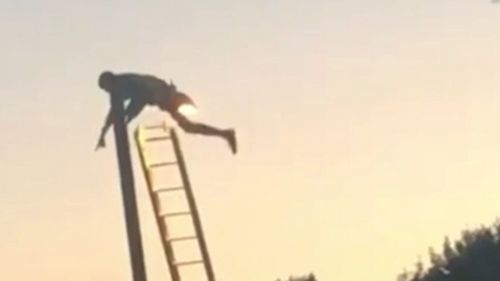 The man became stuck at the top of a lamp post in the UK. Picture: Supplied