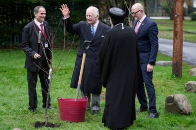King Charles III waves before he plants a tree after attending an Advent Service and Christmas Reception at The Coptic Orthodox Church Centre UK on December 5, 2023 in Stevenage, England