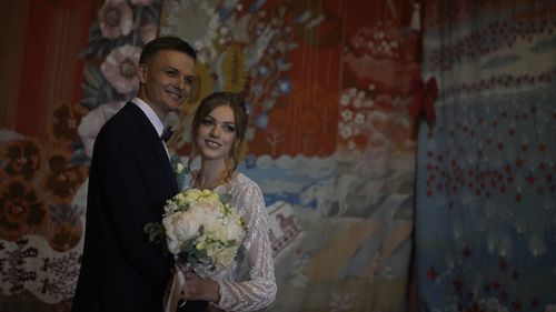 Denys Voznyi and Anna Karpenko pose for a photo before getting married in Kyiv.