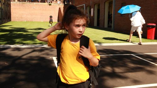 A young girl leaves her school campus in March this year, just before online learning was rolled out across New South Wales.