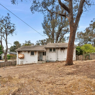 Fixer-upper for sale in the ACT with weathered brick walls listed for $1.1m