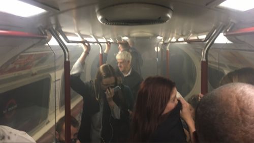 Passengers were forced to breathe through their clothes after smoke filled the carriage. (Twitter / Joe Bunting‏)