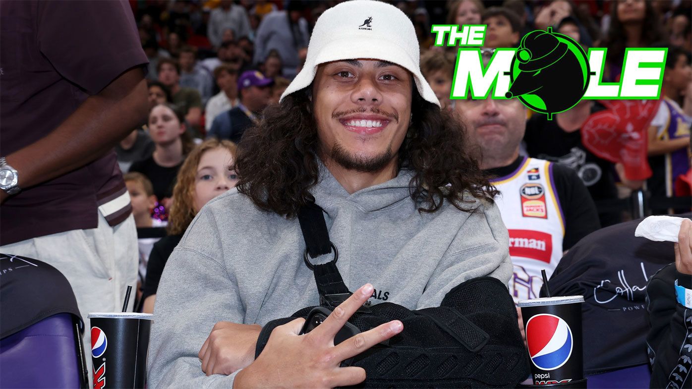 Jarome Luai, with his left arm in a sling, watches a Sydney Kings game from floor seats in November 2023.