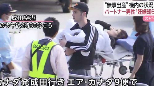 The father, mother and newborn baby leave the plane shortly after landing in Tokyo.