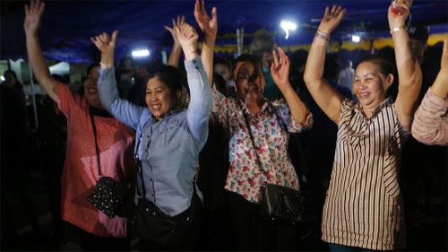 Locals cheer upon news the boys have been freed. Picture: AP