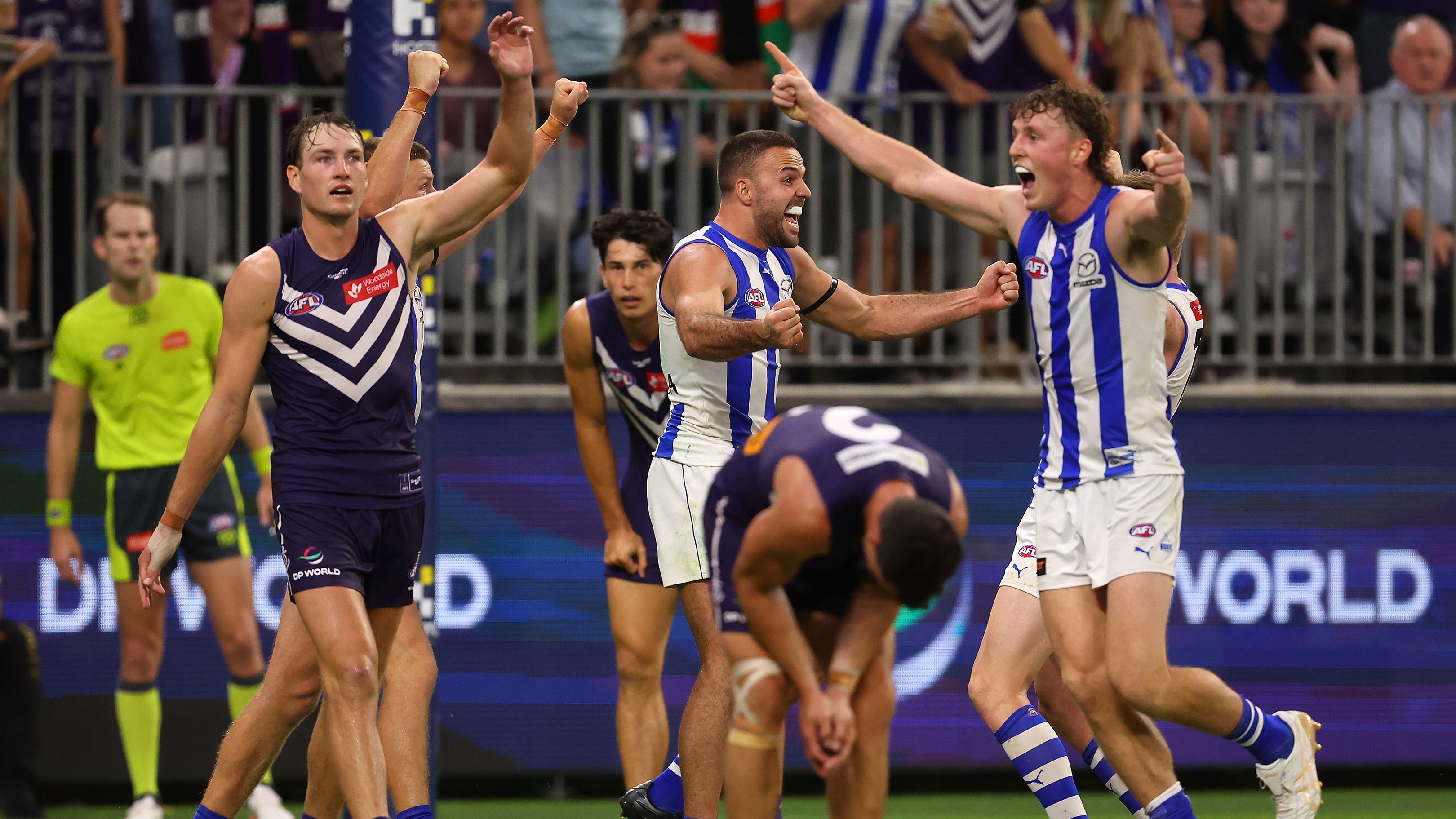 PERTH, AUSTRALIA - MARCH 25: Griffin Logue and Nick Larkey of the Kangaroos celebrate winning the round 2 AFL match between the Fremantle Dockers and North Melbourne Kangaroos at Optus Stadium, on March 25, 2023, in Perth, Australia. (Photo by Paul Kane/Getty Images)