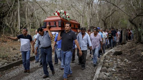 Members of the Solecito search group carry the coffin of Pedro Huesca, a police detective who disappeared in 2013 and was found in a mass grave in 2017, to the cemetery in Palmas de Abajo, Veracruz, Mexico. Huesca's remains are among more than 250 skulls found over the last several months in what appears to be a drug cartel mass burial ground on the outskirts of the city.