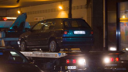 A VW Golf seized by police in Belgium is towed away.